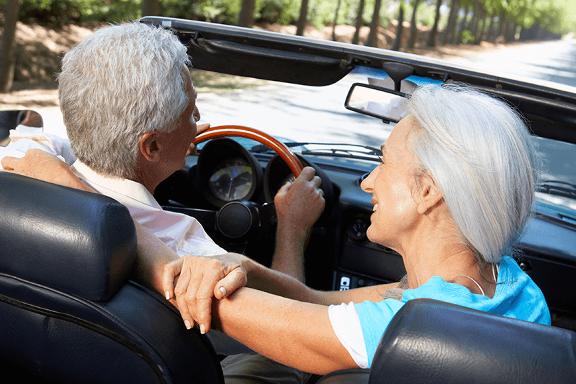 happy couples drives in convertable without back pain