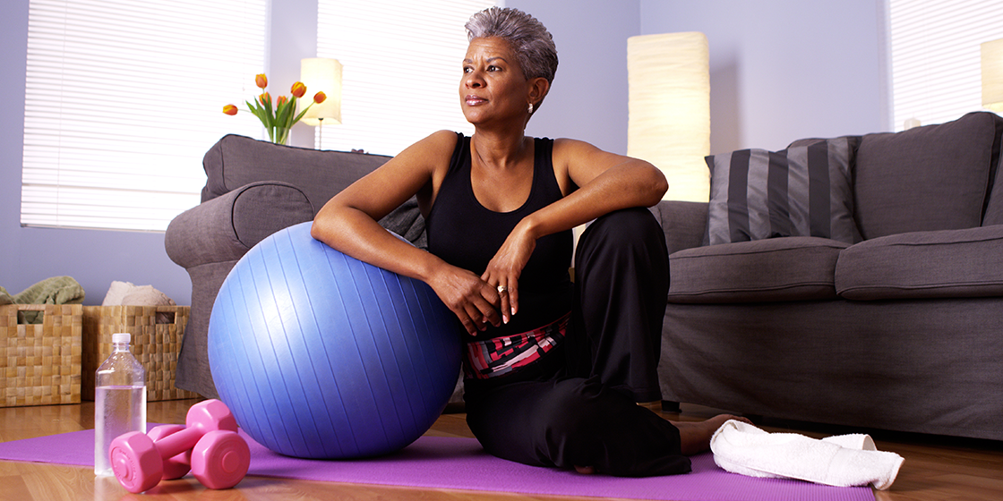 woman exercises at home with yoga ball