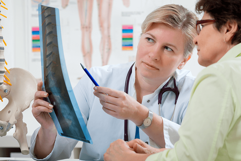 doctor and patient explore back pain sources from x-ray