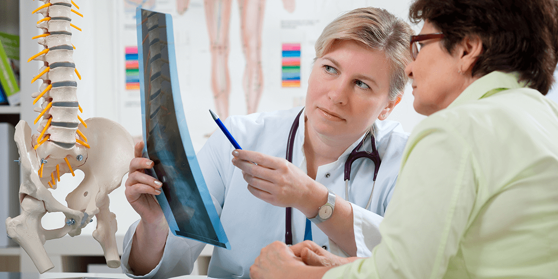 doctor and patient explore back pain sources from x-ray