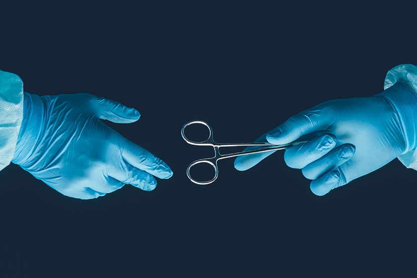 surgeon hands off surgical clamp