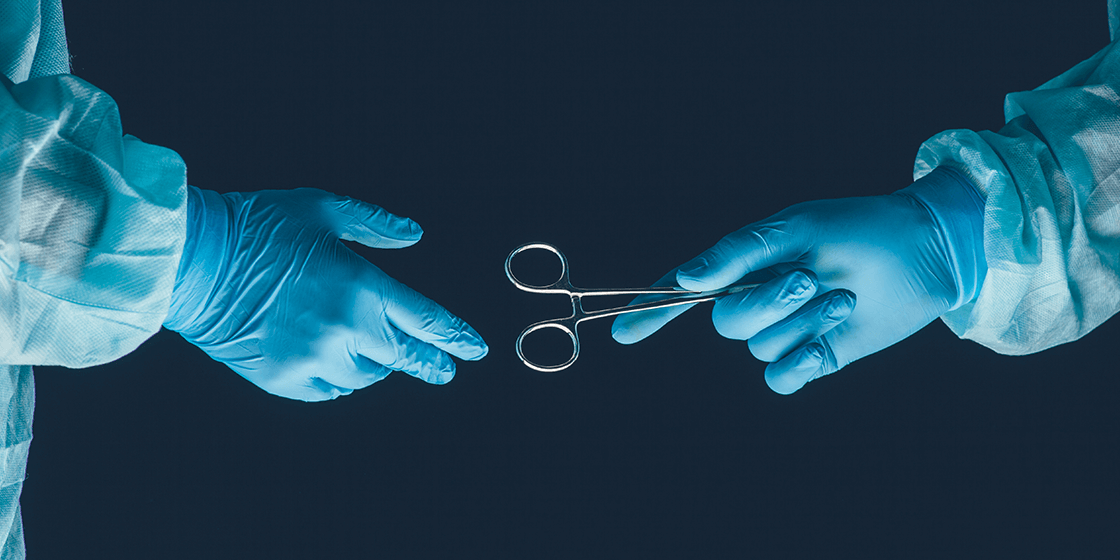 surgeon hands off surgical clamp