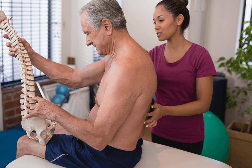 patient with lumbar herniated disc meets with physical therapist