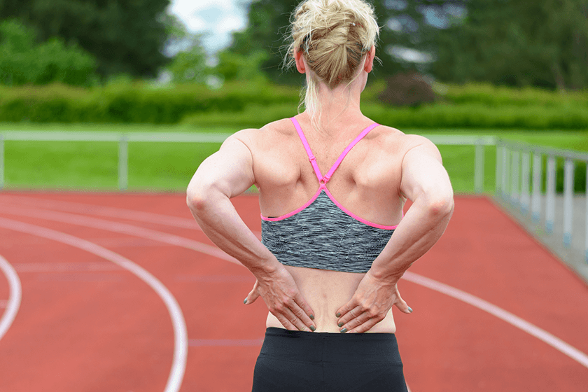 woman with lower back pain from fibromyalgia