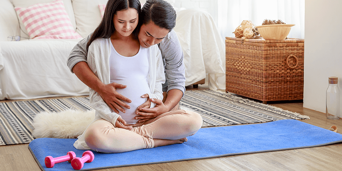 woman preventing lower back pain during pregnancy with exercise