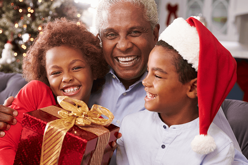 grandfather holding gift for back pain from grandchildren