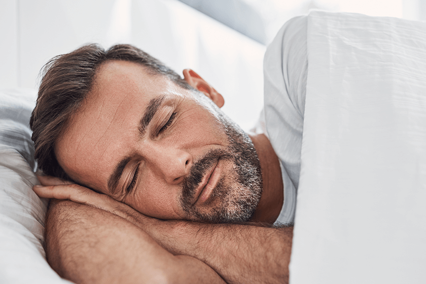 man sleeping with back pain