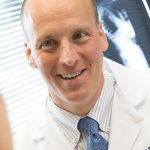 Dr. George S. Naseef speaks with patient