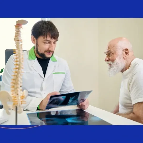 Patient reviewing artificial disc replacement treatment options with a spine specialist.