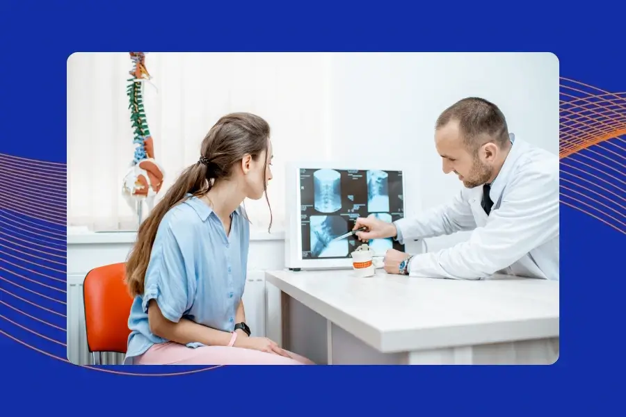 Spine surgeon reviewing recurrent lumbar disc herniation treatment options with a patient.