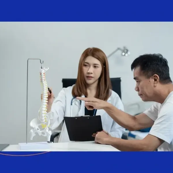Spine specialist explaining microdiscectomy success rates and long-term outcomes to a patient.